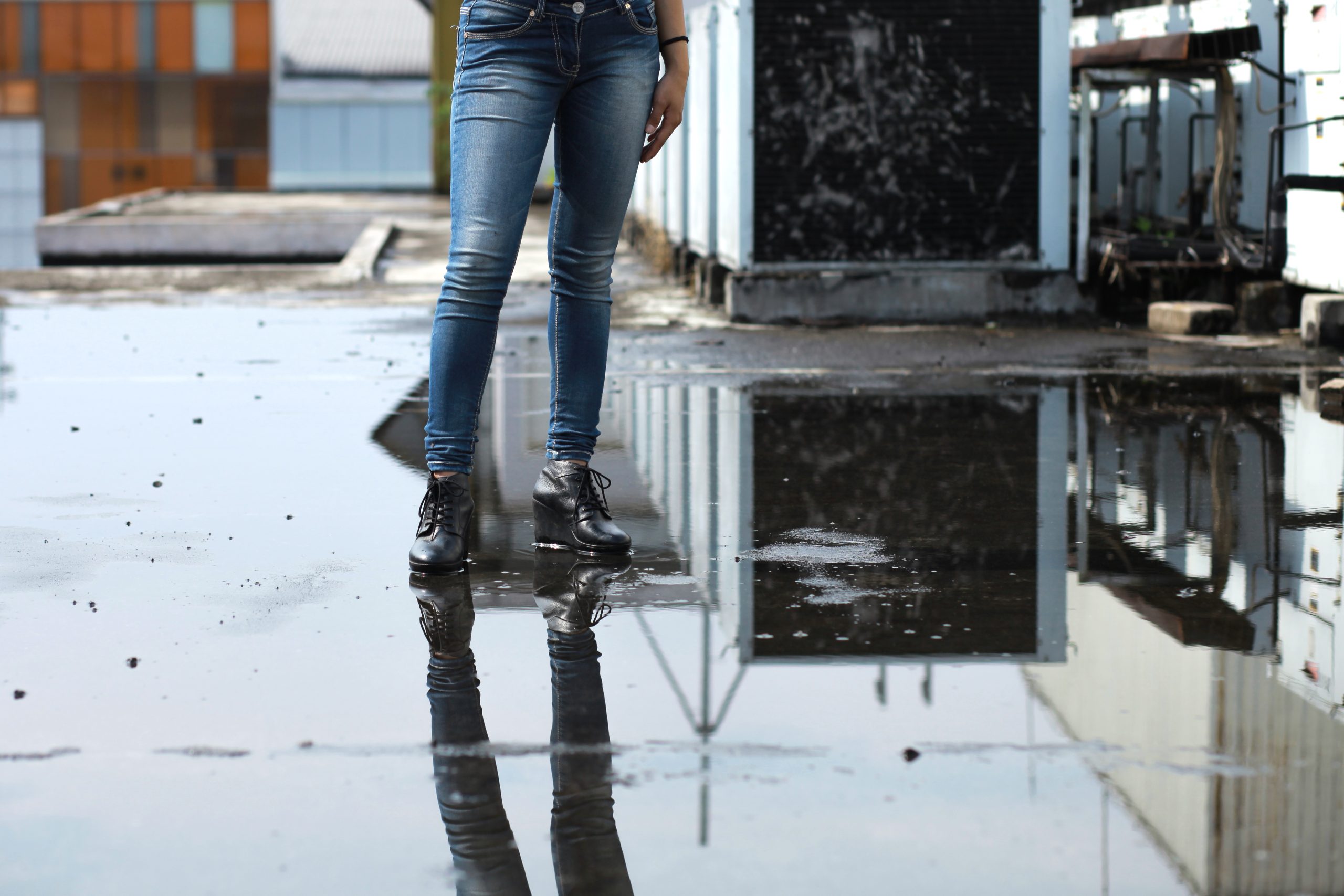 woman standing in a puddle in a flooded warehouse