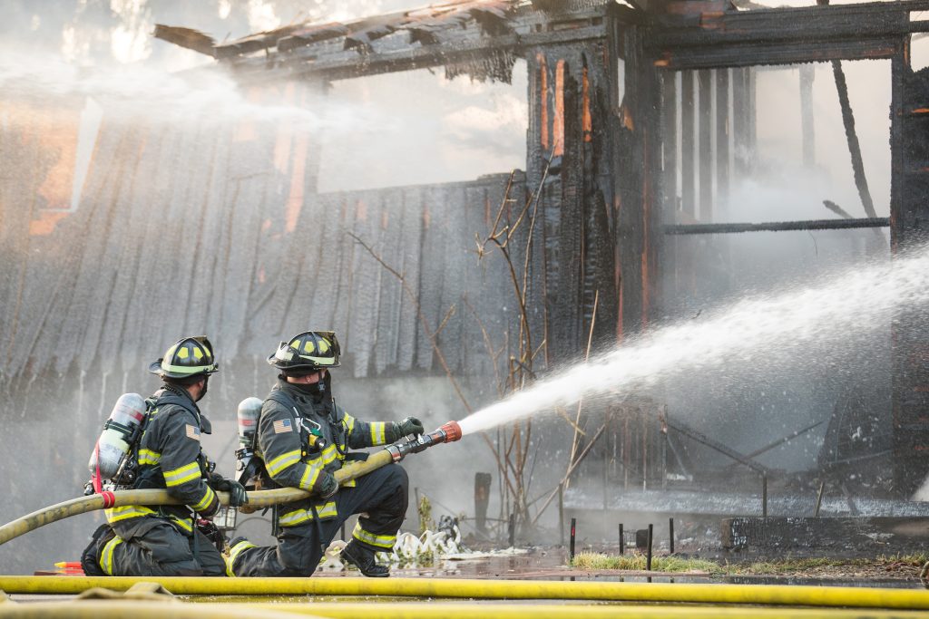 firemen putting out a residential house fire